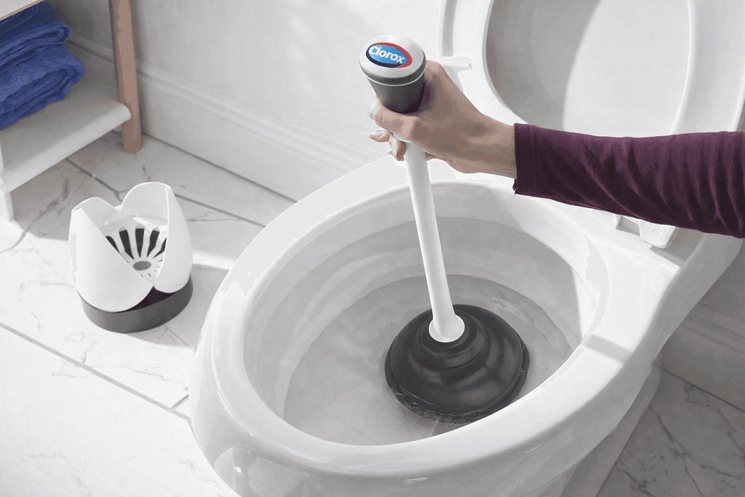 Clorox toilet plunger with flange cup and storage caddy in bathroom setting