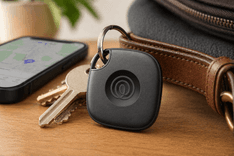 Life360 Tile Bluetooth tracker placed next to wallet and keys