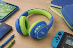 Young child wearing Acer Kids Bluetooth Headphones while using a tablet for online learning at home.