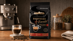 Lavazza Espresso Barista Gran Crema whole bean coffee beside fresh espresso shot and grinder